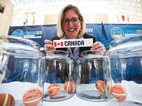 Denise Dignard, director of Women's High Performance, holds Canada's slip during the draw for the 2015 FIBA Americas Championship for Women basketball tournament at City Hall. (Codie McLachlan, Edmonton Sun)