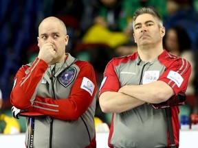 Northwest Territories skip Jamie Koe, left, and teammate Mark Whitehead react during a draw Monday at the Brier in Calgary's Scotiabank Saddledome. (Darren Makowichuk, QMI Agency)