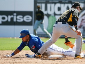 Blue Jays rookies Dalton Pompey steals second base under the glove of the Pirates’ Jung Ho Kang in Grapefruit League action in Dunedin yesterday. The Jays lost 8-7. (Stan Behal/Toronto Sun)