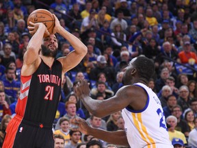Raptors guard Greivis Vasquez shoots the basketball against Warriors forward Draymond Green. It has been a tough year for Vasquez, getting used to playing three different positions. (USA TODAY)