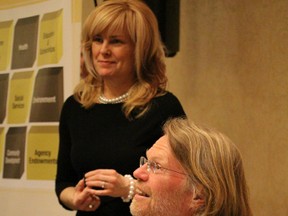 Political author Michael MacMillan signs copies of "Tragedy in the Commons" while Stephanie Ferrara, of Sarnia-Lambton Immigration Partnership, looks on in the background. MacMillan spoke on the importance of citizen engagement at a free public event Tuesday night. BARBARA SIMPSON/THE OBSERVER/QMI AGENCY