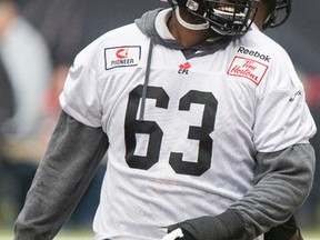 Hamilton Tiger-Cats offensive linesman Marc Dile (63) laughs during practice with the CFL football team at B.C. Place in Vancouver, B.C., on Thursday, Nov. 27, 2014. The 102nd Grey Cup is set for Sunday, Nov. 30, 2014 between the Hamilton Tiger-Cats and the Calgary Stampeders. Ian Kucerak/Edmonton Sun/ QMI Agency