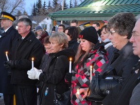 Mayerthorpe residents pay their respects during a candle lighting service at the Fallen Four memorial on Tuesday March 3, 10 years after four RCMP officers were gunned down north of Mayerthorpe.