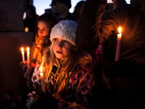 People of all ages paid their respects at the candlelight service at the Fallen Four memorial on Tuesday in Mayerthorpe. The memorial marked 10 years since four RCMP officers were shot and killed by James Roszko. (CHRISTOPHER KING/QMI Agency)