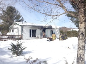 Fire crews douse hot spots in a cottage on De L’Orme Rd. in Val-des-Monts after a blaze Tuesday morning. There were no injuries. (MRC des Collines Police submitted image)
No one was inside the building at the time and firefighters believe the