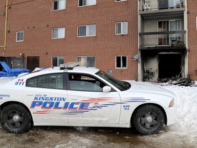 A Kingston Police officer watches over a burned out apartment unit on Wednesday March 4 2015 after a fatal fire which killed an 87-year-old man and injured five others at 107 Compton St. in Kingston on Tuesday evening . Ian MacAlpine/The Kingston Whig-Standard/QMI Agency