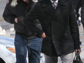 Franck Gervais leaves Ottawa court with his lawyer, Claude Levesque, after pleading guilty to impersonating a military officer. Gervais, 33, will be sentenced on May 11. (TONY CALDWELL Ottawa Sun)