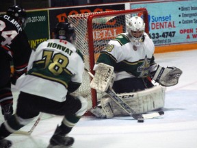 St. Thomas Stars goalie Brendan Polasek tries to corral the puck as teammate Reed Horvat, centre, fends off Sarnia Legionnaires defenceman Cameron Clarke in Game 4 of their first-round playoff series at the Timken Centre in St. Thomas on Tuesday. 
Ben Forrest/Times-Journal/QMI Agency