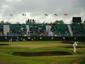 Rickie Fowler of the U.S. plays a shot onto the 18th green during the third round of the British Open at Royal St George's in Sandwich July 16, 2011. (REUTERS/Kieran Doherty)