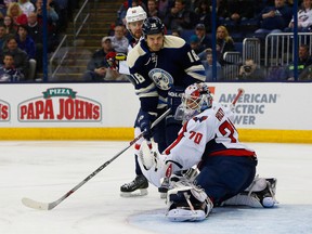 Washington Capitals goalie Braden Holtby (70) stops a tip from Columbus Blue Jackets winger David Clarkson during the second period Tuesday at Nationwide Arena. (Russell LaBounty/USA TODAY Sports)