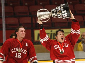 St. Charles Cardinals captain Nathan Scruton (11) celebrates with the NOSSA championship trophy with veteran teammate Andrew Dodge Prescott (12) on Tuesday night in North Bay.
