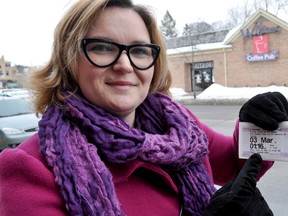 Coun. Tanya Park holds one of the new pay ‘n’ display tickets downtown in London Ont. March 4, 2015. Previously only good in the lot it was purchased in, the tickets are now valid at all other on-street metered parking spots. CHRIS MONTANINI\LONDONER\QMI AGENCY
