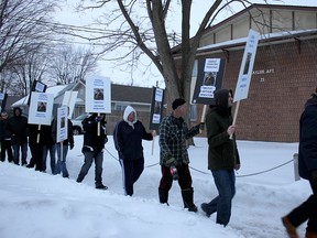 Floyd Porter, right, leads a peaceful protest against a convicted pedophile who neighbours say has moved to Chatham, Ont. from New Brunswick. He was joined by several residents of Taylor Avenue on Wednesday March 4, 2015, who carried placards and shouted slogans such as 'no peace, no rest,' to send a message that the man is not welcome in the community. (Ellwood Shreve, The Daily News)