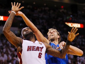 Miami Heat's LeBron James (left) and Dallas Mavericks' Dirk Nowitzki  battle for position during Game 6 of the NBA Finals basketball series in Miami, June 12, 2011. (MIKE SEGAR/Reuters files)