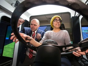 TTC instructor John Beynon attempts to guide Toronto Sun reporter Maryam Shah on a bus simulator at the TTC's Hillcrest Yard Wednesday March 4, 2015. (Craig Robertson/Toronto Sun)