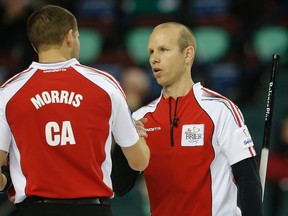 Pat Simmons, right, says it took some time to get back into skip mode after taking over throwing last rocks from John Morris, as their team won its fourth game in a row Wednesday afternoong at the Brier in Calagary. (Darren Makowichuk, QMI Agency)
