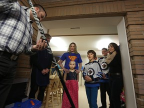 T.J. Stroud gives Keaton Hamin a signed Jets stick. (KEVIN KING/Winnipeg Sun)