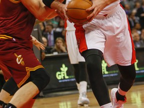 Jonas Valanciunas of the Toronto Raptors works his way by Timofey Mozgov of the Cleveland Cavaliers at the Air Canada Centre in Toronto, Ont. on March 4, 2015. (DAVE THOMAS/Toronto Sun)