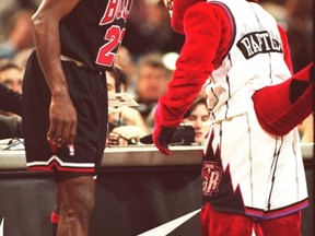 Michael Jordan of the Chicago Bulls has a chuckle over The Raptor's impression of his Chicago teammate Dennis Rodman on March 22, 1998 at the SkyDome. (CRAIG ROBERTSON/Toronto Sun files)