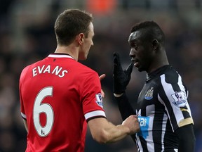 Manchester United's Jonny Evans clashes with Newcastle's Papiss Cisse during Premier League play Wednesday. (Reuters/Lee Smith)