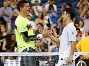 Kei Nishikori of Japan (right) shakes hands with Milos Raonic of Canada after winning the five-set match at the 2014 U.S. Open in New York, in the early hours of Sept. 2, 2014. (Adam Hunger/Reuters/Files)