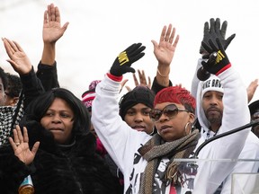 Lesley McSpadden, right, mother of Michael Brown, raises her hands during the National Action Network National March Against Police Violence in Washington December 13, 2014. (REUTERS/Joshua Roberts)