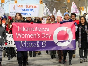 In anticipation of this year's International Women's Day this Sunday (March 8) about two dozen of women and a few men walk throughout downtown Belleville, Ont. to celebrate women's achievements and call for greater equality Thursday morning, March 5, 2015. - JEROME LESSARD/THE INTELLIGENCER/QMI AGENCY