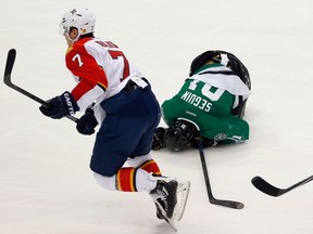 Tyler Seguin of the Dallas Stars falls to the ice after being hit by Dmitry Kulikov #7 of the Florida Panthers in the third period at American Airlines Center on February 13, 2015. (Tom Pennington/Getty Images/AFP)