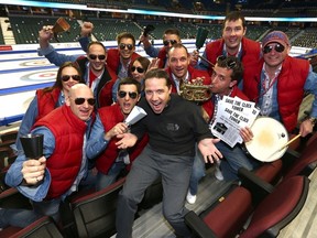 Brier promoter Chris Dornan poses with the Sociables, who are dressed as Marty McFly from the Back to the Future movies, Thursday at the Saddledome in Calgary. Dornan says the Sociables, a group of fans mostly from Edmonton and Calgary who dress in different outrageous costumes for each day of the event, epitomize the event's efforts to inject more excitement into the live fan experience. (Darren Makowichuk, QMI Agency)