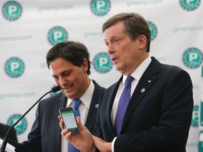 Mayor John Tory, right, with Lorne Persiko, president of city-owned TPA, at announcement of new parking app for Toronto Parking Authority in Toronto, Ont. on Thursday March 5, 2015. (Michael Peake/Toronto Sun)