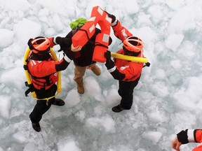 The crew of U.S. Coast Guard Cutter Neah Bay rescue a 25-year-old man attempting to walk across Lake St. Clair, from Detroit to Toronto, March 5, 2015. (Lt. Josh Zike/U.S. Coast Guard/QMI Agency)