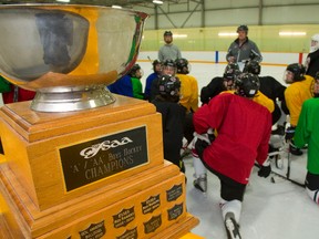 The OFSAA A/AA boys hockey trophy looms large as South coach Mike Stenning talks to his team at practice at Farquharson Arena on Thursday. The Lions head to Pembroke and Petawawa next week to defend their title. (MIKE HENSEN, The London Free Press)