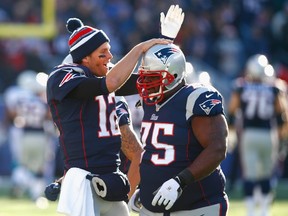 Tom Brady and Vince Wilfork of the New England Patriots react after Kyle Arrington recovered a blocked field goal for a touchdown during the first quarter against the Miami Dolphins at Gillette Stadium on December 14, 2014. (Jared Wickerham/Getty Images/AFP)