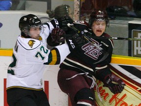 London Knights? Aaron Berisha slams Matthew Timms of the Petes into the board during the first period of their OHL game at the Memorial Centre in Peterborough on Thursday night. The Petes won 4-1. (Clifford Skarstedt, QMI Agency)