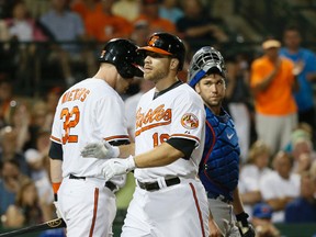 Blue Jays catcher Josh Thole looks on as Baltimore Orioles' Chris Davis is greeted at home plate after his three-run homer on March 5. (Stan Behal, Toronto Sun)