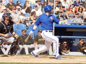 Daric Barton drills a single for the Jays in their Grapefruit League opener on Monday. (EDDIE MICHELS photo)