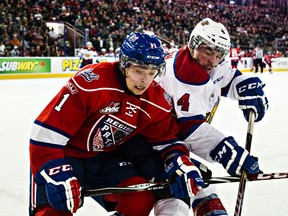 Edmonton's Blake Orban battles along the boards with Regina's Taylor Cooper during the Edmonton Oil Kings' WHL hockey game against the Regina Pats at Rexall Place in Edmonton, Alta., on Friday, Jan. 16, 2015. Codie McLachlan/Edmonton Sun/