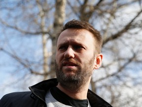 Alexei Navalny, a Russian opposition leader, talks to the media as he walks out of a detention center in Moscow March 6, 2015. Navalny walked out of a Moscow detention center on March 6, a week after fellow opposition leader Boris Nemtsov was shot dead in what his allies say was a political killing aimed at intimidating them.  REUTERS/Maxim Shemetov