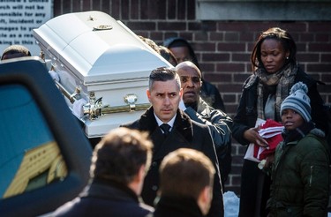 Pallbearers carry the casket of three-year-old Elijah Marsh, as his mother Georgette Marsh (R) walks behind the procession, following his funeral in Toronto, February 28, 2015.  REUTERS/Mark Blinch
