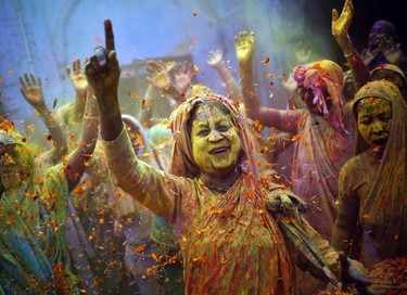 Widows daubed in colours dance as they take part in the Holi celebrations organized at a widows' ashram at Vrindavan in the northern Indian state of Uttar Pradesh March 4, 2015. REUTERS/Anindito Mukherjee
