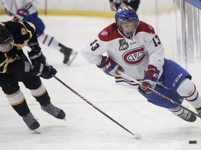 Kingston Voyageurs Brett Seney rides the boards to get the puck during Game 2 of the Ontario Junior Hockey League Eastern Conference finals. (Julia McKay/Kingston Whig-Standard/QMI Agency file photo)