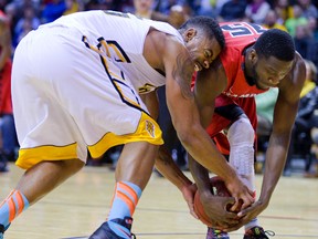 Marvin Phillips of the London Lightning and Richard Amardi of the Brampton A's fight for a loose ball. (Free Press file photo)