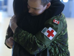 Lt (Navy) Dr. Jeff Praught embraces his girlfriend, Ottawa lawyer Linda Cinanni who he hasn't seen since Dec. 2, 2014. Praught was one of 35 Canadian soldiers returning after a humanitarian mission to West Africa to treat and contain people with the Ebola virus.
DOUG HEMPSTEAD/Ottawa Sun/QMI AGENCY