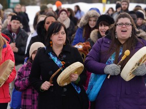 People demonstrate during a vigil honouring women from around the world to raise awareness about the Missing and Murdered Aboriginal Women movement and the Shine A Light campaign at Trent University in Peterborough, Ont., March 4, 2015. (CLIFFORD SKARSTEDT/QMI Agency)