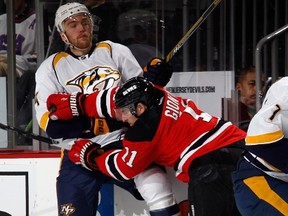 Eric Nystrom of the Nashville Predators is checked by Stephen Gionta of the New Jersey Devils during the first period at the Prudential Center.  (Bruce Bennett/AFP)