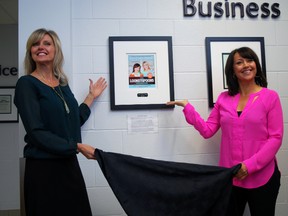 Sisters Greta, left, and Janet Podleski unveil their plaque on the St. Thomas Wall of Fame on Friday, March 6, 2015 at the Timken Community Centre in St. Thomas. They grew up in St. Thomas and became a major success story in Canadian publishing, thanks to 'Looneyspoons' and other best-selling cookbooks. (Ben Forrest, Times-Journal)
