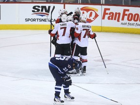 Dustin Byfuglien is doubled over in pain after Erik Condra scored for the Senators during Wednesday's game.