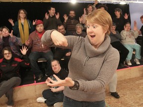 As students from the H'art Centre give the American Sign Language sign for "applause" behind her, deaf actor Elizabeth Morris demonstrates the use of facial and body language. (Michael Lea/The Whig-Standard)