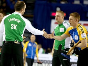 Team Saskatchewan skip Steve Laycock shakes hands with Team Alberta's Marc Kennedy after they won 6-5 during Day 6 of the 2015 Tim Hortons Brier at the Scotiabank Saddledome in Calgary, Alta. on Thursday March 5 2015. Darren Makowichuk/Calgary Sun/QMI Agency