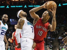 Raptors guard DeMar DeRozan (right) tries to shoot the ball around Hornets guard Mo Williams in Charlotte. (Jeremy Brevard-USA TODAY Sports)